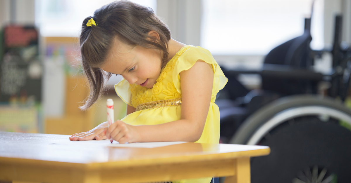 Young child trying hard to write