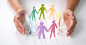 Hands cradling around colourful figures